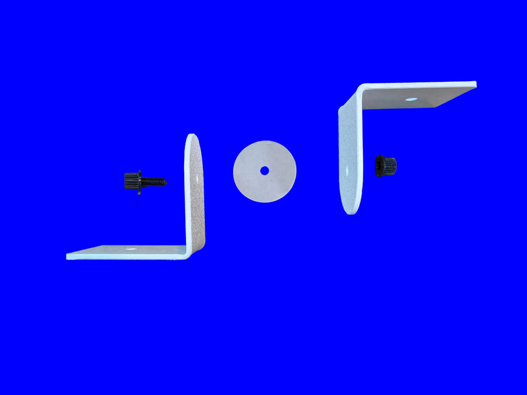 Two white metal L-brackets with black mounting screws and a circular clear spacer, laid out on a brown cardboard background.